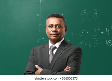 confident-indian-teacher-standing-near-260nw-566508373
