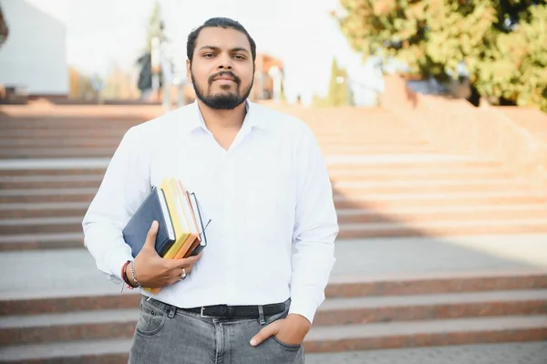 depositphotos_623383446-stock-photo-indian-student-backpack-holding-books